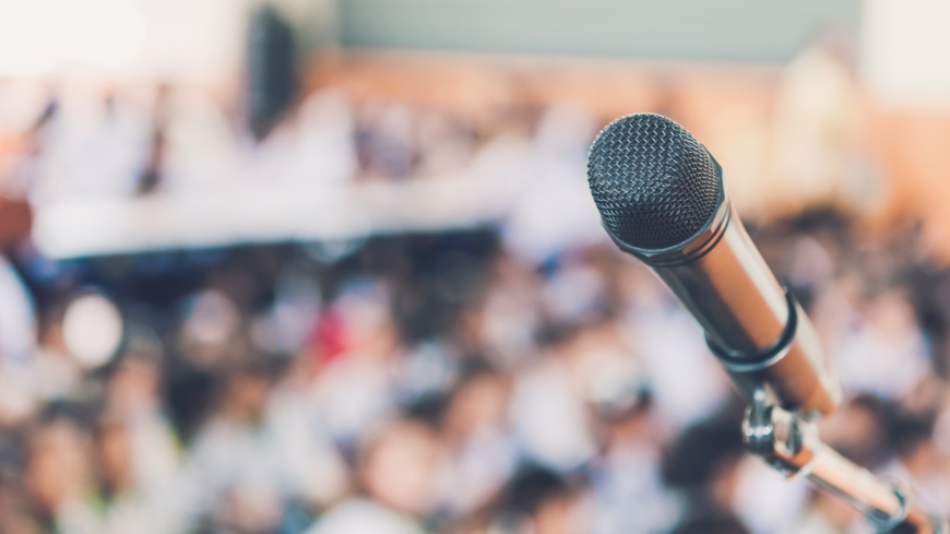 Blurred and Soft focus of head microphone on stage of Education meeting or event whit blurred background,Education meeting and event on stage concept and copy space; Shutterstock ID 1041710362; Project Name: ISD